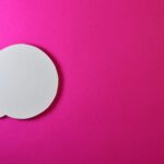 Minimalist pink background with a white speech bubble for creative design projects.